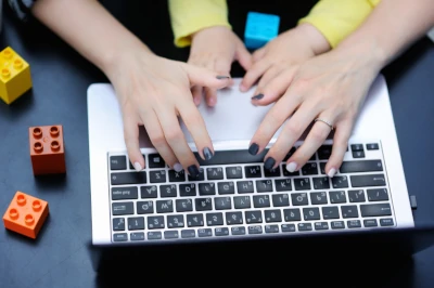 Adults and child using laptop