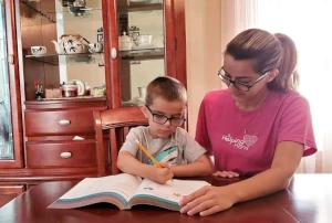 Helper and child doing homework